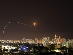 A streak of light is seen as Israel's Iron Dome anti-missile system intercepts rockets launched from the Gaza Strip towards Israel, as seen from Ashkelon, Israel May 16, 2021.