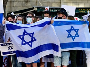 People hold Israeli flags during a Pro-Israel demonstration in front of the Israeli Embassy in Madrid, Spain, on Thursday, May 20, 2021.