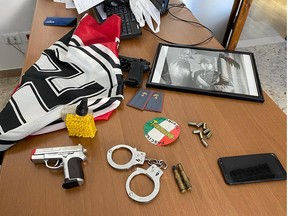 An Italian police handout photo shows weapons, Nazi flags and a picture of dictator Benito Mussolini from the homes of members of a far-right movement celebrating white supremacism and allegedly trying to build a new fascist party, during an operation carried out in 18 Italian provinces, in Italy, May 20.
