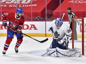 Goaltender Jack Campbell of the Maple Leafs makes a glove save near Tomas Tatar of the Montreal Canadiens during Game 3 at the Bell Centre on May 24, 2021 in Montreal.