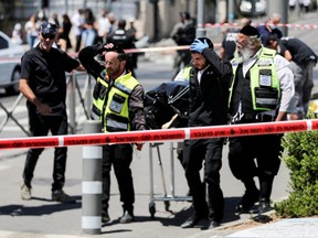 Israeli rescue personnel work at the scene of a stabbing incident in Jerusalem, Monday, May 24, 2021.