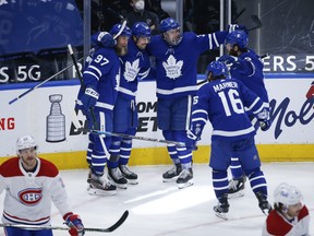 Maple Leafs' Auston Matthews celebrates his 40th goal of the season with teammates during the third period against the Canadiens in Toronto on Thursday, May 6, 2021.