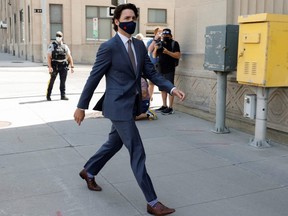 Prime Minister Justin Trudeau walks to a news conference, as efforts continue to help slow the spread of COVID-19, in Ottawa, Tuesday, May 18, 2021.