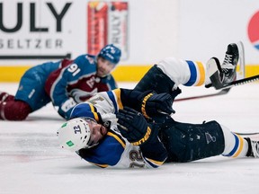 Blues defenceman Justin Faulk (front) falls to the ice after being hit in the third period by Avalanche centre Nazem Kadri (back) in Game 2 of the first round of the 2021 Stanley Cup Playoffs at Ball Arena in Denver on Wednesday. The NHL suspended Kadri eight games for his hit on Friday, May 21, 2021.