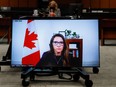Katie Telford, Chief of Staff to Canada's Prime Minister Justin Trudeau, appears on a screen as she attends a House of Commons defence committee meeting on sexual misconduct in the armed forces, in Ottawa, May 7, 2021.