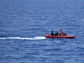 In this handout image courtesy of the US Coast Guard the Coast Guard Cutter Resolute small boat crew rescues 8 people from the water approximately 18 miles southwest of Key West, Florida, May 27,2021.