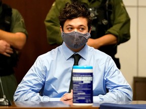 Kyle Rittenhouse, the teenager charged with killing two people and injuring another during demonstrations on the streets of Kenosha, Wisconsin, listens to defence attorney John Pierce during an extradition hearing in Lake County in Waukegan, Illinois, October 30, 2020.