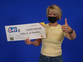 Kathy Roksa with her Lotto 649 winnings.
