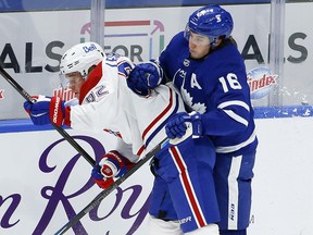 Maple Leafs forward Mitch Marner hits Canadiens forward Artturi Lehkonen in Toronto on Thursday, May 6, 2021.