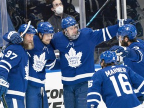 Toronto Maple Leafs Auston Matthews, centre, celebrates scoring his 40th goal with Toronto Maple Leafs Joe Thornton (97) during the third period against the Montreal Canadiens at Scotiabank Arena in Toronto, May 6, 2021.