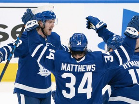 Auston Matthews (centre) celebrates with Toronto Maple Leafs teammates after a goal against the Montreal Canadiens on Saturday in Toronto.