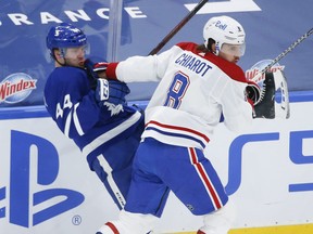 Canadiens' Ben Chiarot hits Maple Leafs defenceman Morgan Rielly during Thursday's game in Toronto.
