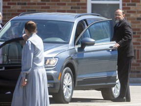 Henry Hildebrandt, pastor of the Church of God in Aylmer, leaves the church after attending it for about two hours with dozens of congregation members on Thursday May 13, 2021. They were there as a judge in nearby St. Thomas began deliberating whether to padlock the church as it continues to hold Sunday services in breach of Ontario's laws that limit gatherings to slow COVID-19's spread. (Mike Hensen/The London Free Press)