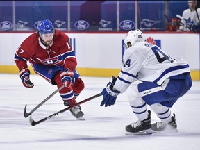 Josh Anderson of the Montreal Canadiens, left, and Morgan Rielly of the Toronto Maple Leafs skate after the puck during the third period at the Bell Centre on May 3, 2021 in Montreal.