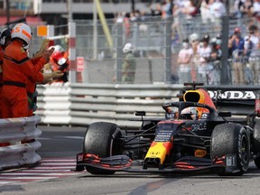 Track marshalls applause Red Bull's Dutch driver Max Verstappen after he won the Monaco Grand Prix at the Monaco street circuit in Monaco, Sunday, May 23, 2021.