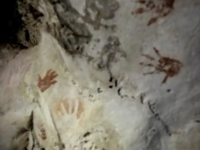Handprints, reportedly 1,200 years old, are seen on the cave walls, in Merida, Mexico April 2021, in this screengrab taken from a handout video.
