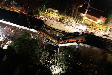 A general view of damage caused after a railway overpass and train collapsed onto a busy road in this drone picture obtained from social media Mexico City, Mexico May 4, 2021. Picture taken with a drone. INSTAGRAM @CSDRONES/via REUTERS