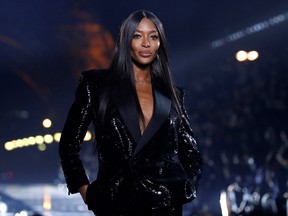 Naomi Campbell presents a creation by designer Anthony Vaccarello as part of his Spring/Summer 2020 women's ready-to-wear collection show for fashion house Saint Laurent during Paris Fashion Week in Paris September 24, 2019.