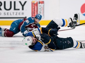 St. Louis Blues defenceman Justin Faulk (72) falls to the ice after being hit by Colorado Avalanche centre Nazem Kadri in the first round of the 2021 Stanley Cup playoffs at Ball Arena.
