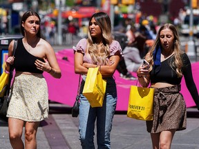 People walk without protective masks in Times Square amid the coronavirus pandemic in the Manhattan borough of New York,  May 4, 2021.