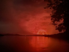 This general view taken on May 22, 2021 from Tchegera Island outsoide Goma on the lake Kivu in the East of the Democratic Republic of Congo shows flame spewing from the Nyiragongo volcano.