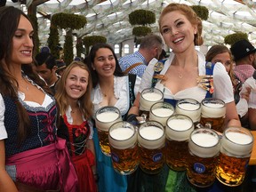 This file photo taken on September 21, 2019 shows a waitress serving beer after the opening of Oktoberfest in a festival tent at the Theresienwiese fair grounds in Munich, Germany.