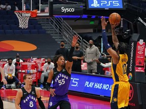 Indiana Pacers forward Oshae Brissett, right, attempts a three point shot over Toronto Raptors forward Freddie Gillespie during the first half at Amalie Arena in Tampa, Fla., May 16, 2021.