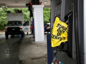 A bagged nozzle at a pump notifies motorists that it no longer has fuel after a cyberattack crippled the biggest fuel pipeline in the country, run by Colonial Pipeline, in Chapel Hill, North Carolina, May 12, 2021.