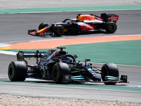 Mercedes driver Lewis Hamilton and Red Bull's Max Verstappen (back) compete during the Portuguese Grand Prix race at the Algarve International Circuit in Portimao on May 2, 2021.