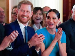 Prince Harry and his wife Meghan, Duchess of Sussex, cheer during the annual Endeavour Fund Awards at Mansion House in London, March 5, 2020.