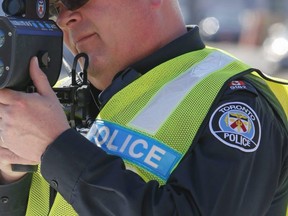 A real sure sign of spring as Toronto 12-div. Pc. Dave Burnell does radar on Jane St. at Weston Rd. in Toronto, Ont. on Sunday April 12, 2015. Dave Thomas/Toronto Sun/QMI Agency