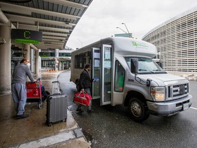 Travellers from an international flight line up at Pearson airport to board a shuttle that will take them to a quarantine hotel in Mississauga February 24, 2021.