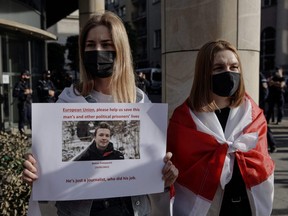 A woman displays a sign during a protest against the detention of Belarusian blogger, Roman Protasevich, who was detained as a Ryanair plane that he was on, en route from Athens to Vilnius, was forced to land in Minsk on Sunday, in Warsaw, Poland, Monday, May 24, 2021.