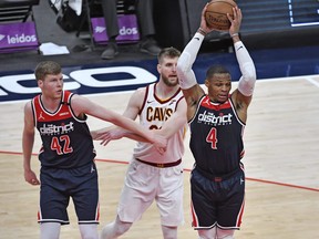Washington Wizards guard Russell Westbrook, right, grabs a rebound against the Cleveland Cavaliers during the fourth quarter at Capital One Arena in Washington, D.C., May 14, 2021.