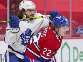 Toronto Maple Leafs defenceman Timothy Liljegren tangles with Montreal Canadiens rookie Cole Caufield during the first period at the Bell Centre in Montreal on May 3, 2021.