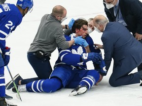 Maple Leafs medical staff attend to forward John Tavares after a collision with Montreal Canadiens forward Corey Perry (not pictured) during the first period in Game 1 of the first-round of the Stanley Cup Playoffs at Scotiabank Arena on Thursday, May 20, 2021.