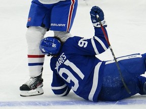 Toronto Maple Leafs forward John Tavares is hit on the head by Montreal Canadiens forward Corey Perry after falling on May 20, 2021.