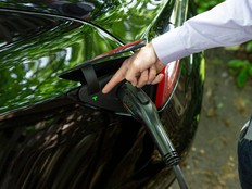 Ben Rich charges his Tesla vehicle in his backyard in Montclair, N.J., May 6, 2021.