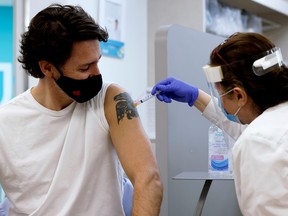 FILE PHOTO: Canada's Prime Minister Justin Trudeau is inoculated with AstraZeneca's vaccine against coronavirus disease in Ottawa