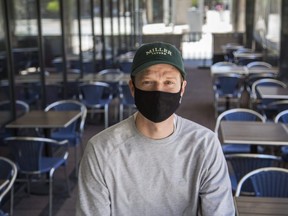 Justin Murray, assistant manager at Miller Tavern, among the empty patio tables by the Scotiabank Arena in Toronto, Ont.  on Thursday May 27, 2021.