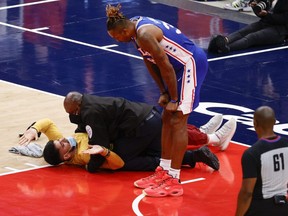 Dwight Howard of the 76ers looks down at a fan who ran onto the court and was tackled by security in the third quarter of Game 4 of the Eastern Conference first round series against the Wizards at Capital One Arena in Washington, D.C., Monday, May 31, 2021.