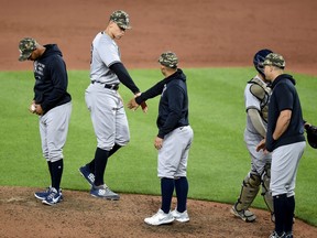 Aaron Judge, second from left, of the New York Yankees celebrates with teammates after a 8-2 victory against the Baltimore Orioles at Oriole Park at Camden Yards on May 15, 2021 in Baltimore, Md.