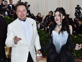 In this file photo taken on May 7, 2018 Elon Musk and Grimes arrive for the 2018 Met Gala, at the Metropolitan Museum of Art in New York.