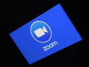 In this file photo illustration a Zoom App logo is displayed on a smartphone on March 30, 2020 in Arlington, Virginia.