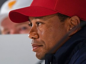 In this file photo Captain of the US team Tiger Woods (R) speaks during a press conference as International Team captain Ernie Els of South Africa (L) listens ahead of the Presidents Cup golf tournament in Melbourne on December 10, 2019.