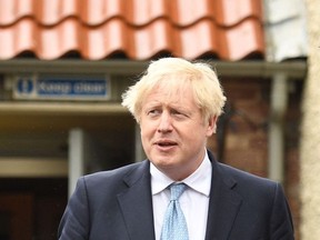 Britain's Prime Minister Boris Johnson reacts as he leaves Jacksons Wharf pub in Hartlepool, northeast England on May 7, 2021 during a visit following the Conservative Party by-election victory in the constituency. - Prime Minister Boris Johnson on May 7 welcomed early election results in Britain's first major vote since Brexit and the pandemic, including a stunning by-election victory for his Conservative party in the opposition Labour stronghold of Hartlepool in northeast England.