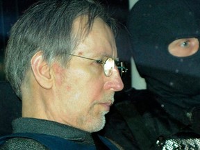 In this file photo taken on May 13, 2008, French self-confessed serial killer Michel Fourniret arrives in a police car to attend his trial at the Charleville-Mezieres courthouse, northern France.