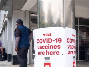 In this file photo signs offering Covid-19 vaccinations are seen outside of a CVS pharmacy in Washington, DC on May 7, 2021.