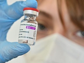 In this file photo taken on March 24, 2021 a medical worker holds a vial of the AstraZeneca vaccine.