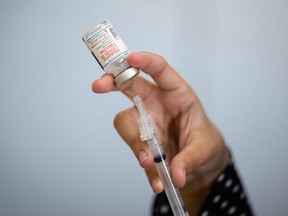 In this file photo taken on April 16, 2021, a medical staff member prepares a syringe with a vial of the Moderna Covid-19 vaccine at a pop up vaccine clinic at the Jewish Community Center in the Staten Island borough of New York City.